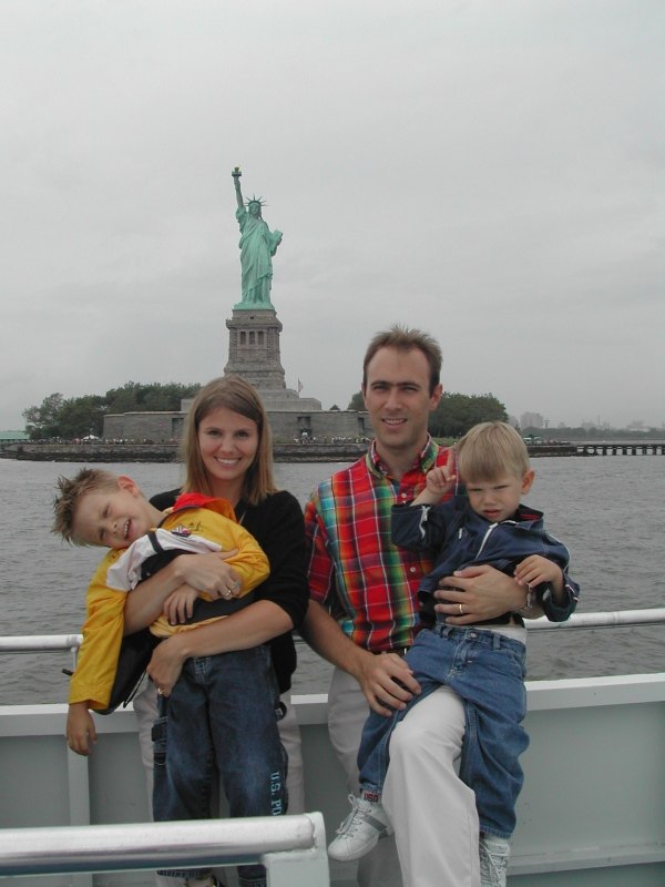 Matt, Dani, Kevin, and Ryan on the New York harbor cruise near the Statue of Liberty