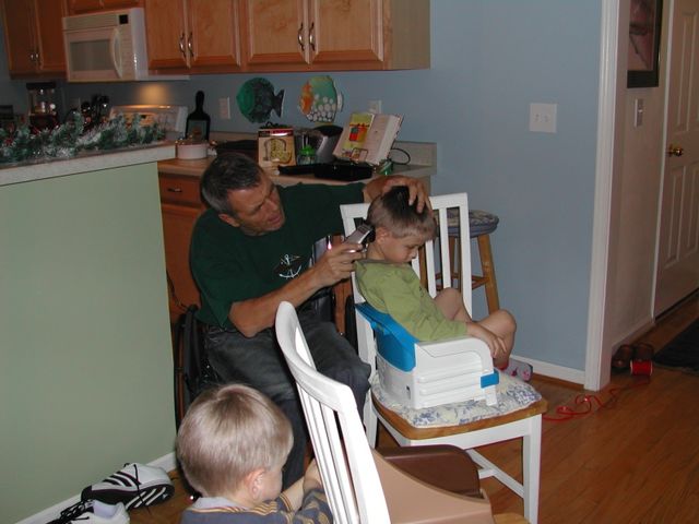 Grandpa (Sandu) giving Kevin a haircut