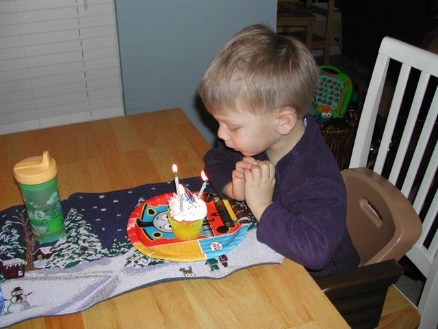 Ryan blowing out the candles on his cupcake on his actual birthday