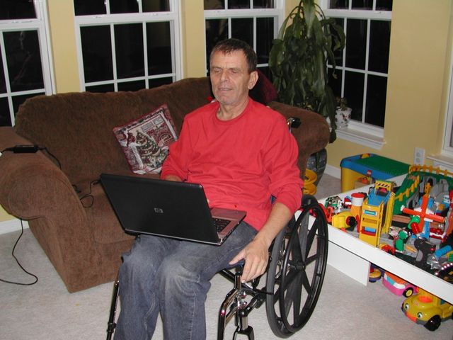 Sandu with his laptop in the sunroom