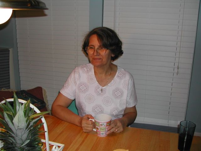 Gina with her tea at the dinette table