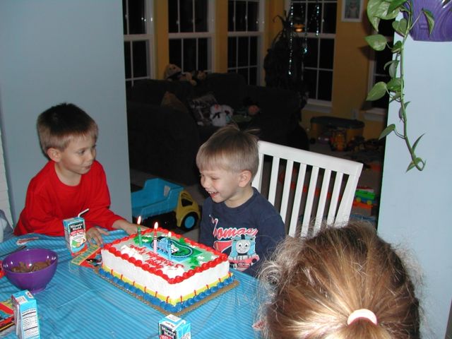 Ryan is ready to blow out the candles on his Thomas the train birthday cake
