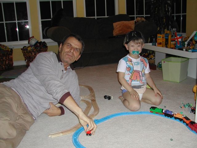 Grandpa (Sandu) playing on the floor with Ryan and his trains
