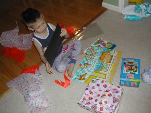 Kevin opening presents on his 5th birthday