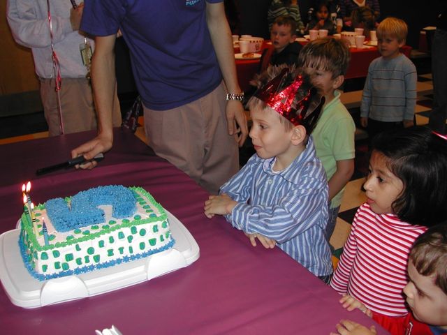 Kevin and friends with the cake at his 5th birthday party at Pump It Up