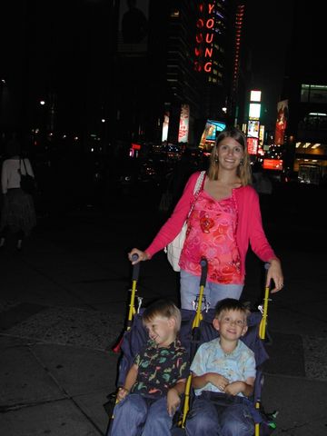 Dani pushing Kevin and Ryan in a stroller at night in Manhattan