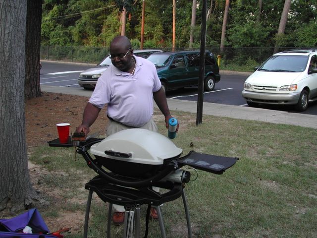 Geoff Williams grilling at his apartment in Columbia, SC
