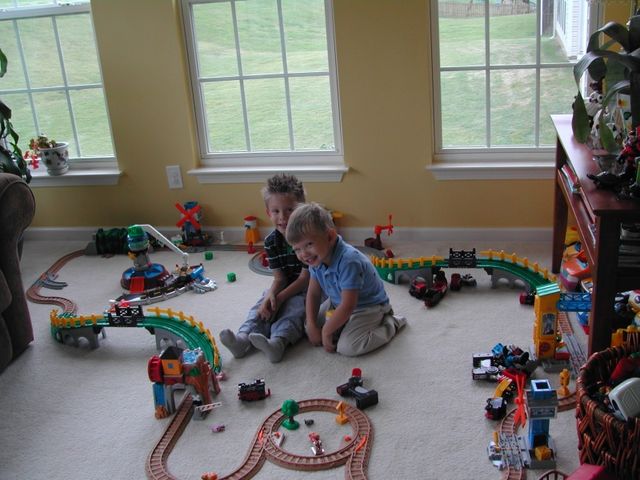 Kevin and Ryan playing with trains in the sunroom